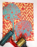 Decorative paper with cut-out dandelion designs on a colorful background